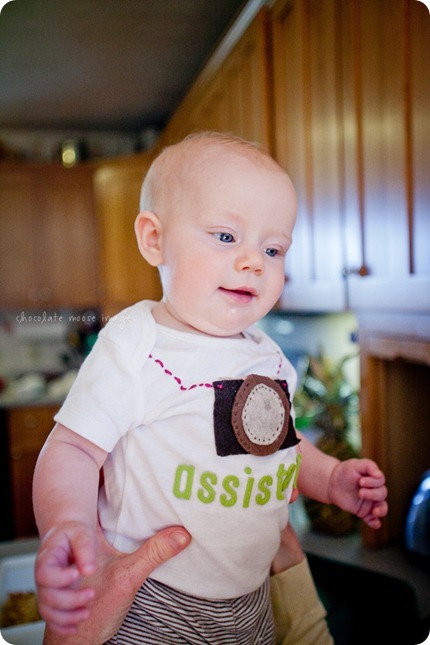 Little Charlotte models the assistant onesie showing her excitement to assist Chocolate Moose Images