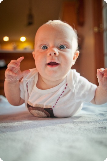 Little Charlotte models the assistant onesie showing her excitement to assist Chocolate Moose Images