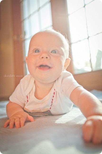 Little Charlotte models the assistant onesie showing her excitement to assist Chocolate Moose Images