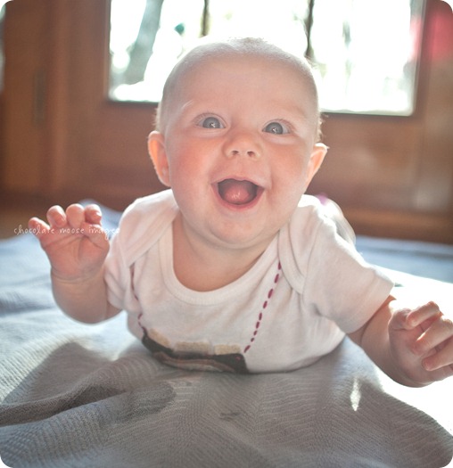 Little Charlotte models the assistant onesie showing her excitement to assist Chocolate Moose Images