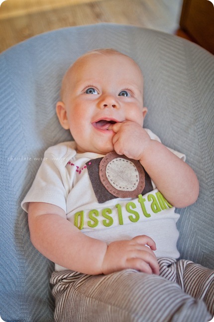 Little Charlotte models the assistant onesie showing her excitement to assist Chocolate Moose Images