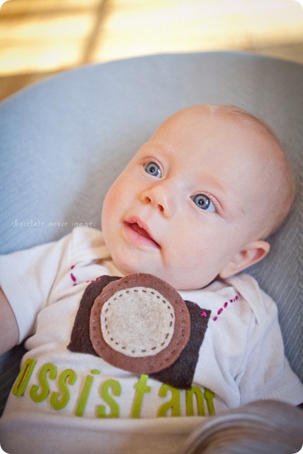 Little Charlotte models the assistant onesie showing her excitement to assist Chocolate Moose Images