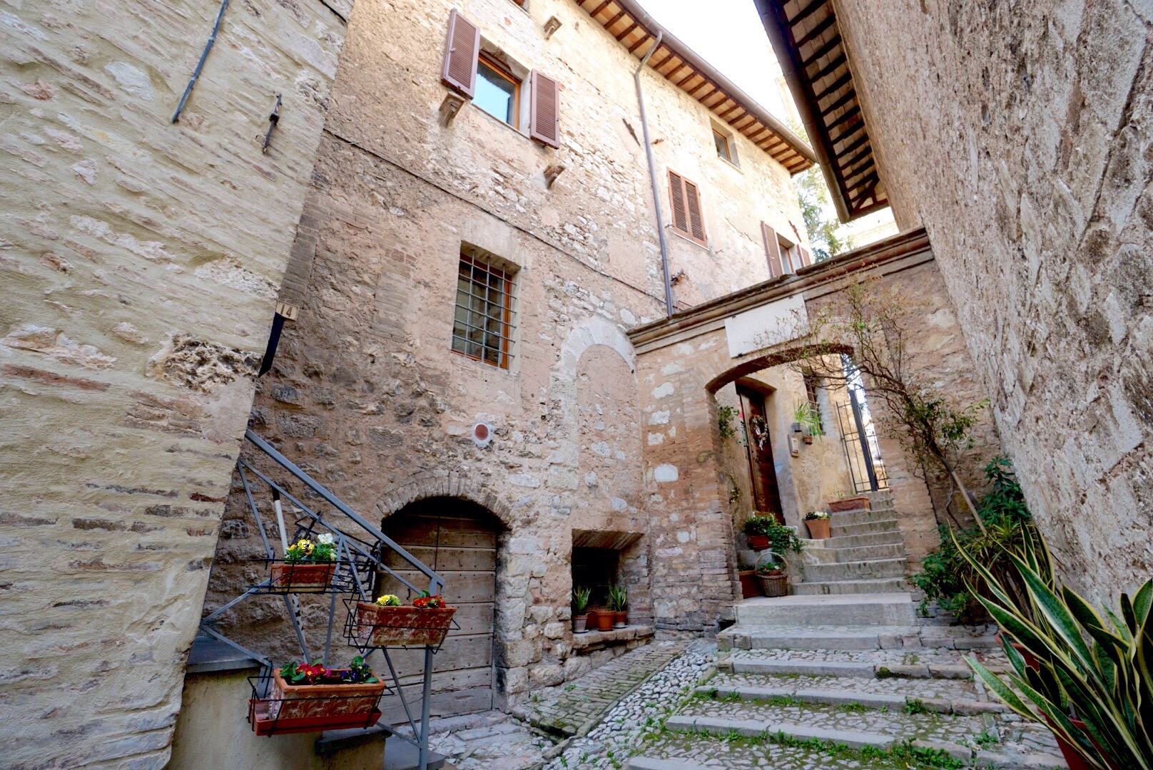a hidden street in Trevi with lovely plants and stairs every which way